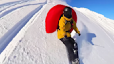 Snowboarder deploys avalanche airbag mid-air to see if it can help him fly