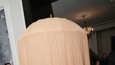 This celeb traveled to the Met Gala under a head-to-toe beige umbrella