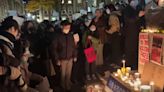 Hundreds across US hold up blank sheets of paper while protesting in solidarity with Chinese citizens