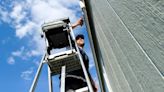 Zion's Bank employees paint the home of Logan veteran