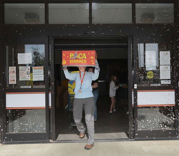 PHOTOS: Volunteers come out to help Feed Rogers relocate food after Sunday’s storms | Northwest Arkansas Democrat-Gazette