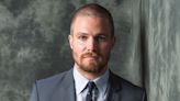 Stephen Amell suits back up as lead of “Suits” spinoff