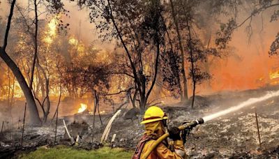 California’s largest wildfire explodes in size as fires rage across US West