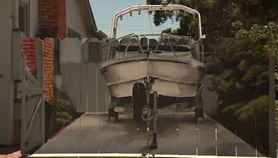 Man gets boat painted on fence that city made him put up to hide it