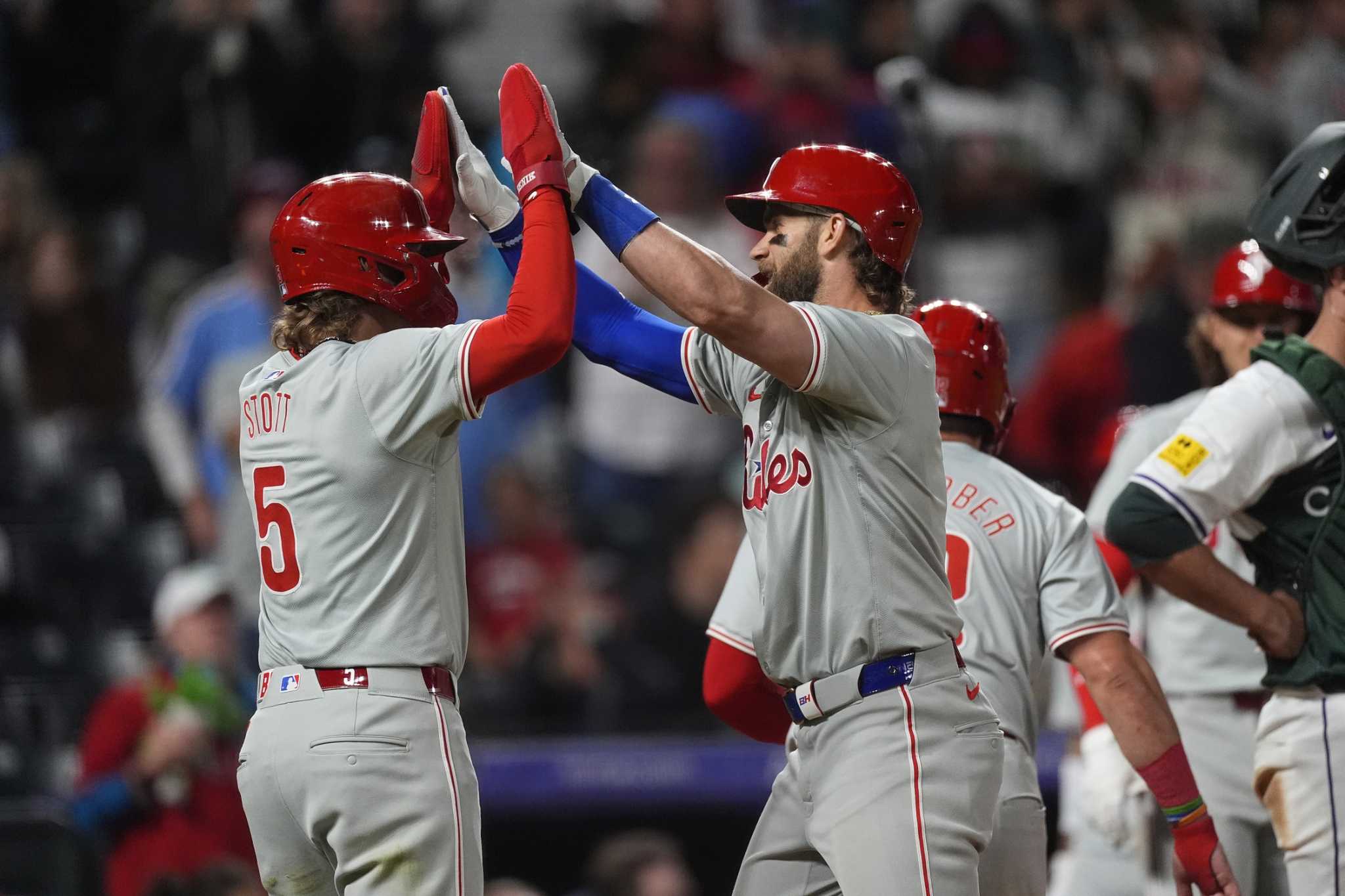 Bryce Harper hits a 3-run homer in Phillies' 9th-inning rally to beat Rockies 8-4