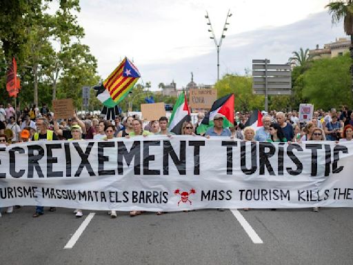 Barcelona anti-tourism protesters fire water pistols at visitors