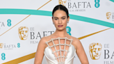 Lily James is the belle of the BAFTA red carpet in revealing pearl caged white dress