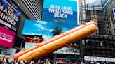 Meat me in Times Square: artists create giant 65ft-long hot dog sculpture for the New York plaza