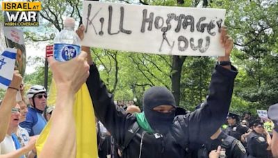 Masked maniac flashes vile ‘Kill Hostages Now’ sign amid NYC Israel Day Parade