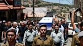 Mourners at the northern Israel funeral of one of eight soldiers killed in a blast near Gaza's Rafah