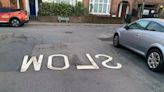 Backwards spelling of 'SLOW' on road confuses locals