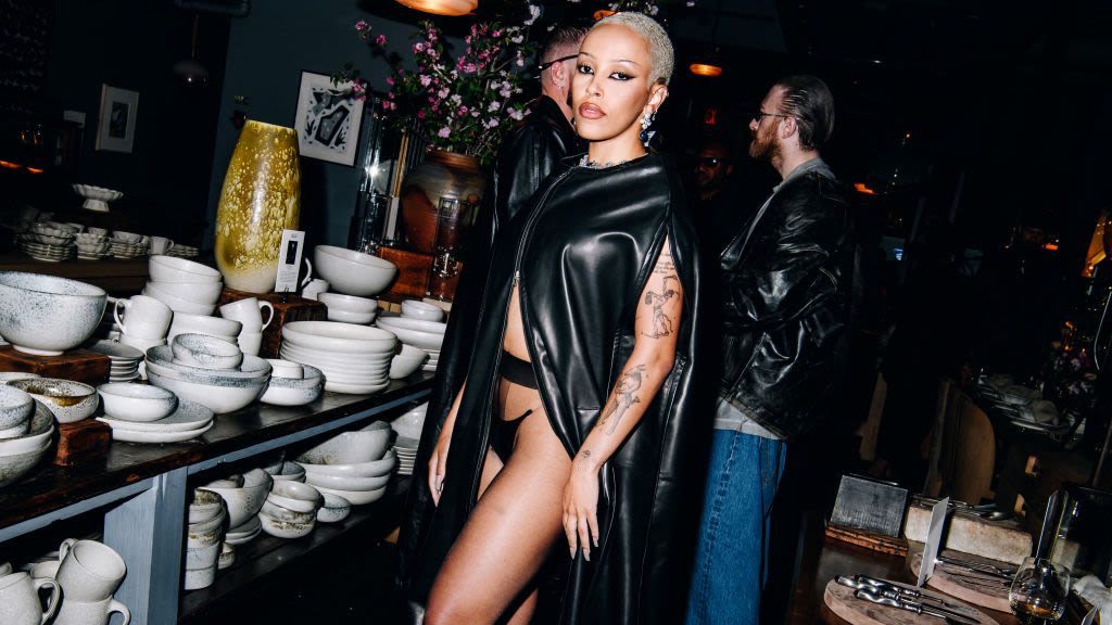 Doja Cat Looks Like a Hot Garment Bag in This Pleather Cape and Thong