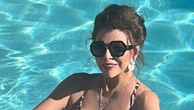 Joan Collins, 91, dances in plunging swimsuit during lavish holiday