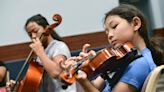 Aspiring musicians learn basics of stringed instruments at Destin summer camp