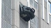 Car dangling from uptown Charlotte parking deck