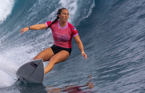 American Carissa Moore began defense of her Olympic surfing title, wins first heat