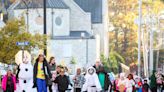 Costumed Locust Street students march in downtown Columbia parade with Marching Mizzou