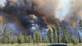 Wind-driven wildfire spreads outside a central Oregon community and prompts evacuations