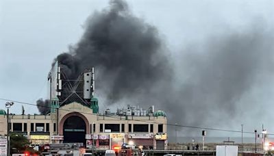 Black smoke can be seen billowing out of a structure on the Atlantic City Boardwalk