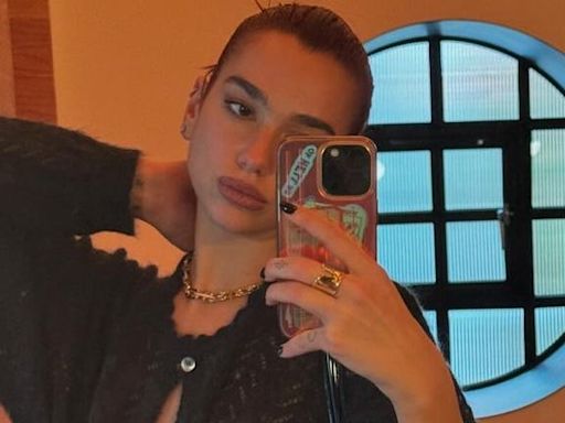 Dua Lipa’s pinstripe corset top is giving office siren