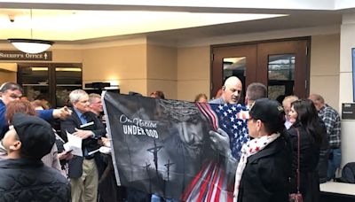 Protesters to satanic speaker at Ottawa County board pack foyer before meeting