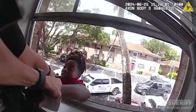 Florida woman dangles from window in attempt to flee police