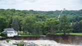 Swollen river claims house next to Minnesota dam as flooding and extreme weather grips the Midwest