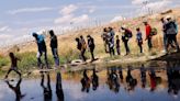 With barbed wire and warnings, migrants stopped at US-Mexico border