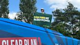 Greenpeace protester mounts Tory bus demanding 'clean power not Paddy Power'