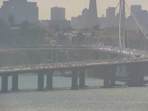 Man jumps into Bay Bridge after vehicle overturns, coast guard rescues him