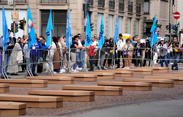 Mock coffins fill a square in Milan in a protest over workplace safety in Italy