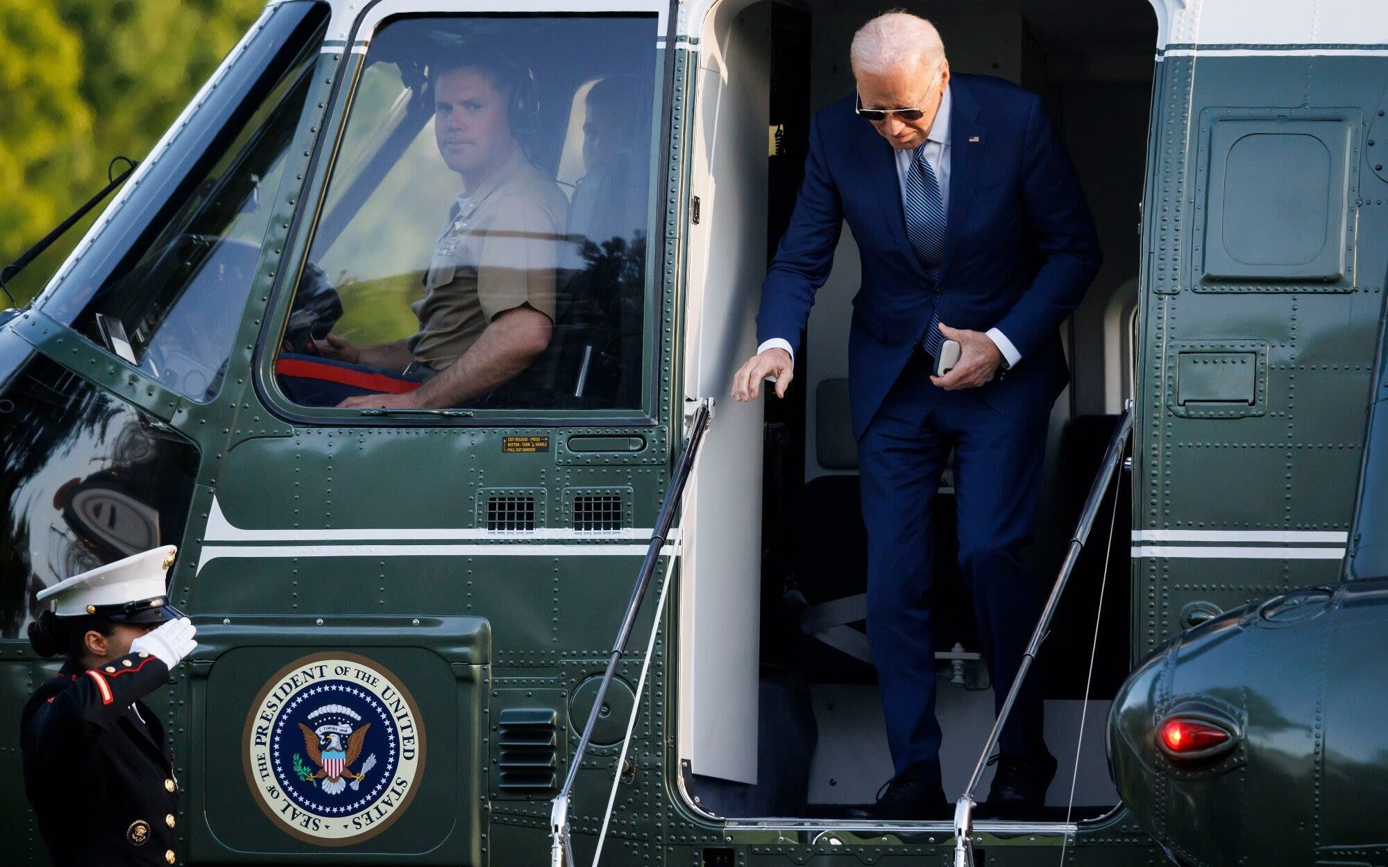 Pictured: Joe Biden ‘uses team of walkers to hide shuffling gait’ to Marine One