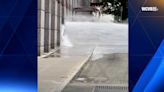 Water gushes across Boylston Street from Boston convention center