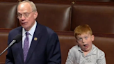 Congressman’s son, 6, pulls silly faces while father gives House of Representatives speech