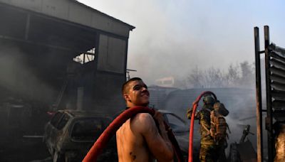 Drop in winds offers hope as Greek firefighters battle huge wildfire scorching the fringes of Athens