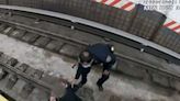 Police officers save woman who fainted and fell onto New York City subway tracks