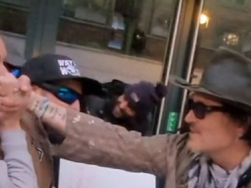 Johnny Depp is mobbed by fans in London and kisses one on the hand