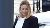 Margot Robbie flashes midriff in cropped white top