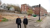 Auburn apartments, restaurant building on Main Street moving forward