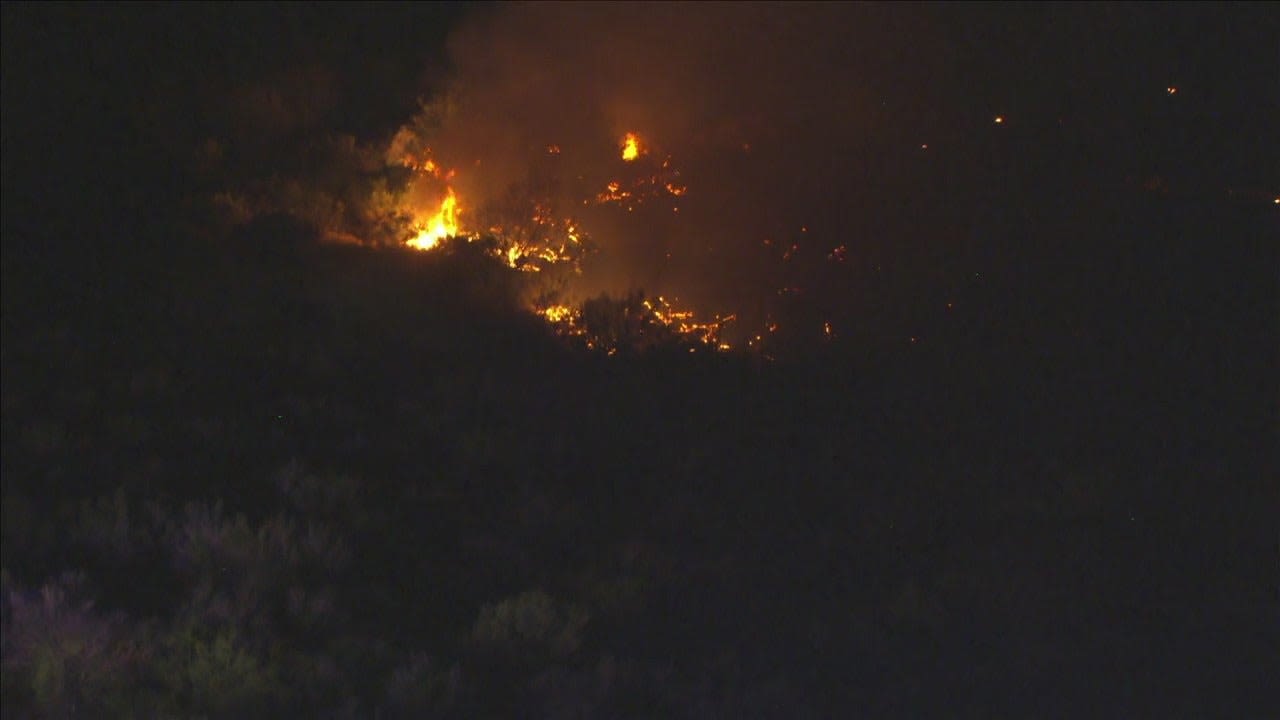 Brush fire emits smoke into night sky in Avondale