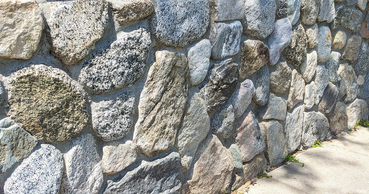 How to construct a strong retaining wall using natural materials