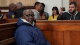 Rwandan genocide suspect appears in court holding Bible after 22 years on the run