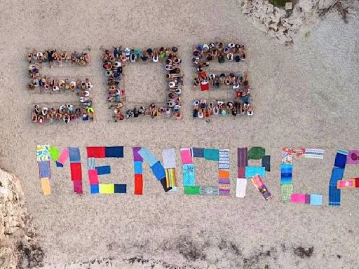 Hundreds of anti-tourism protesters on beach form 'SOS Menorca'