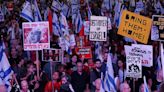 People attend a protest against Israeli Prime Minister Benjamin Netanyahu's government in Tel Aviv