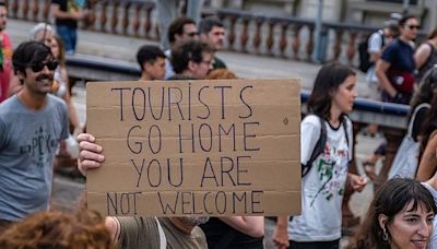 Barcelona residents protest over mass tourism by squirting tourists with water guns