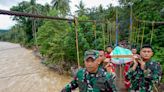 Rescuers search for dozens buried in an Indonesian landslide that killed at least 11 people