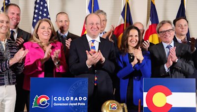 Polis signs Colorado budget, touts funding for schools and affordable housing