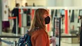 Terri Irwin carries Mickey Mouse luggage through the airport