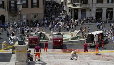 Activists pour red paint down Rome’s famed Spanish Steps in outrage over femicides in Italy