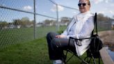 Teresa Mauer watches her granddaughter play softball for Cretin- Derham Hall in St. Paul, Minnesota, on May 3, 2024.